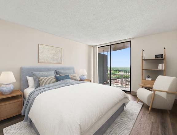 A bedroom with a large bed, a nightstand with a lamp, a chair, and a bookshelf.