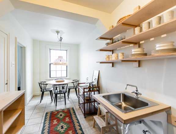 a kitchen with a sink and a table and a window