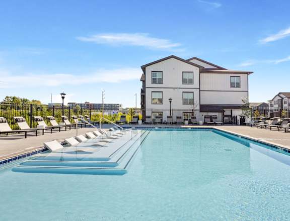 A large swimming pool in front of a building.