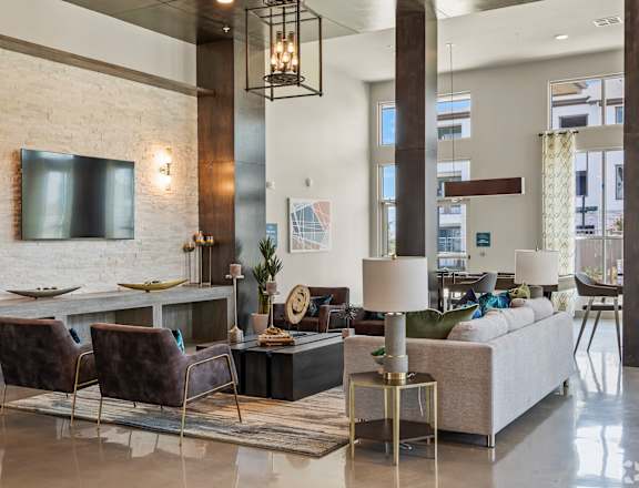 a living room filled with furniture and a large window