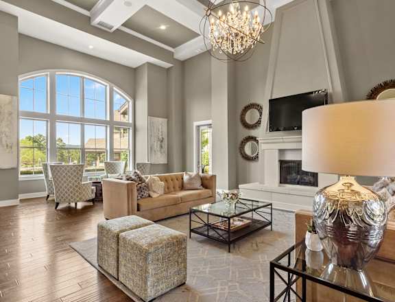 a living room with a fireplace and a large window at The Ridge at Chenal Valley, Little Rock, Arkansas