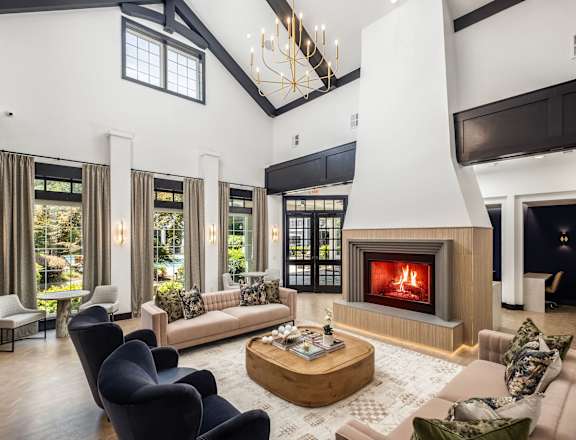 A modern living room with a fireplace and a large window.
