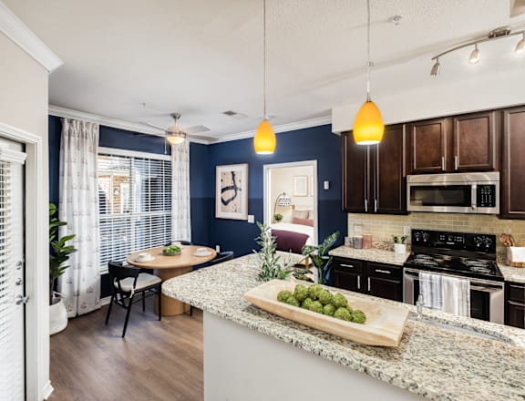 A kitchen with a countertop and a dining table.