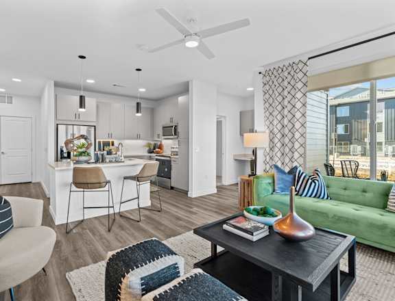 an open living room with a kitchen and a dining room