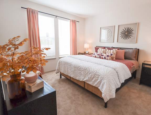 a bedroom with a bed and two windows at The Crest at Acworth, Acworth