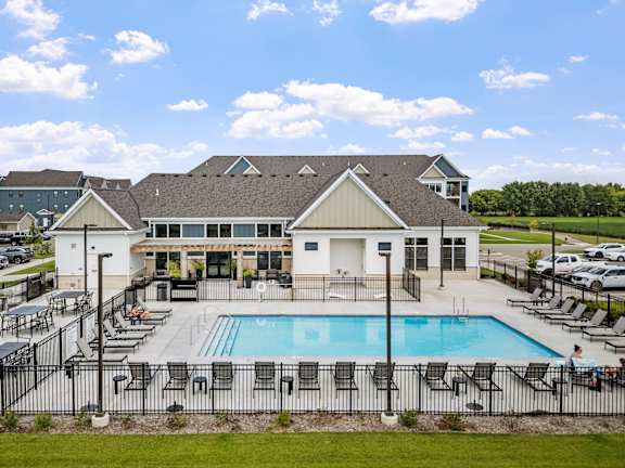A large building with a pool in front of it.