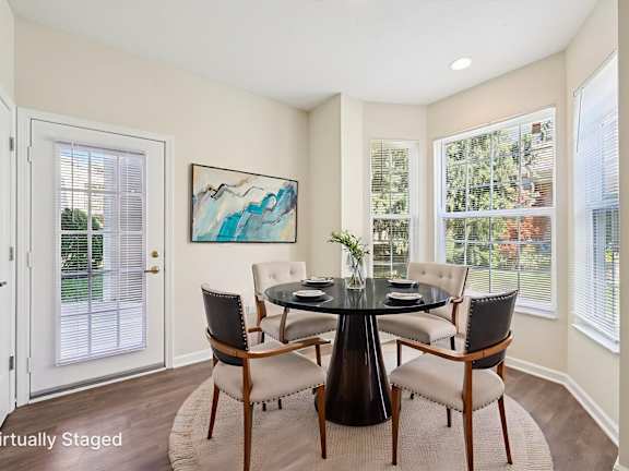 a living room with red couches and chairs and a table