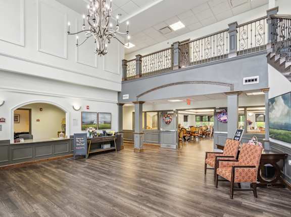 A large room with a staircase and a chandelier.