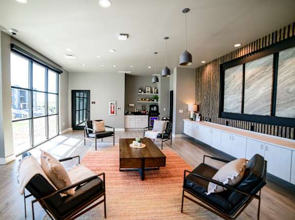 a living room with a couch and chairs and a table