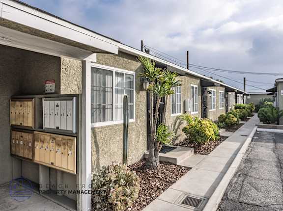 A row of houses with a sign that says "No Parking" on the front of the first house.
