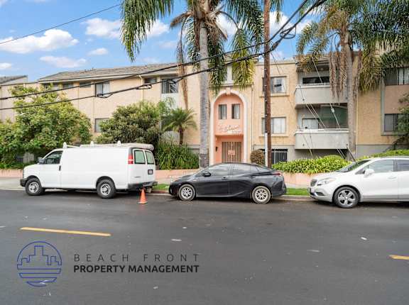 three cars parked in front of an apartment building