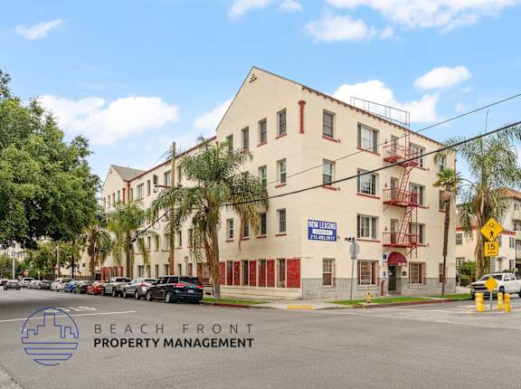 A street view of a building with the sign "BEACH FRONT PROPERTY MANAGEMENT" in front of it.