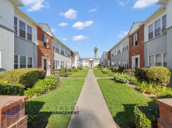 A row of houses with a pathway in the middle.