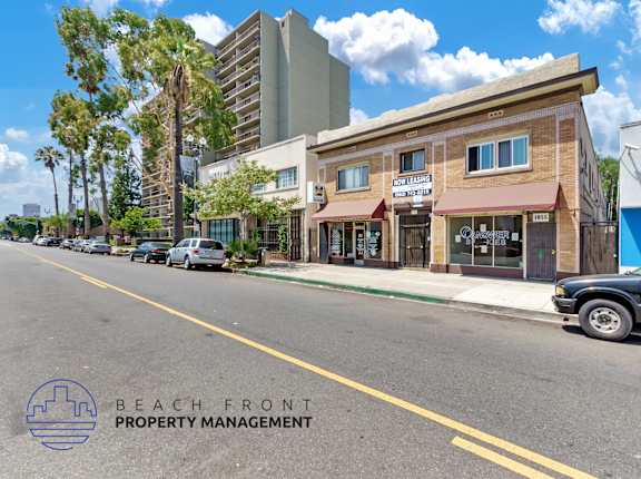 a street view of the beach front property management building on the corner of a street