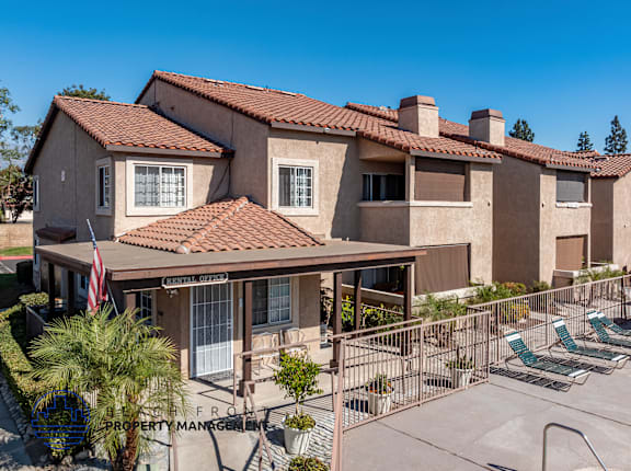 A sunny day at a residential complex with a clear blue sky.