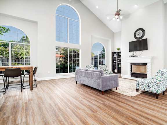 A living room with a fireplace and a television.