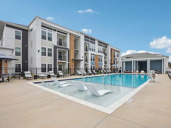 a swimming pool in front of an apartment building