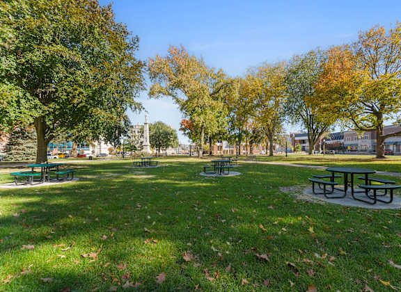 A park with green grass and trees.