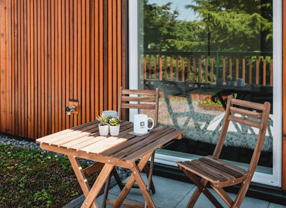 a table and chairs on a patio next to a window