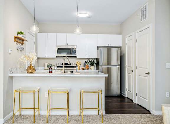 a kitchen with white cabinets and a white counter top