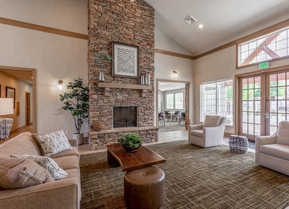 a large living room with a stone fireplace and furniture