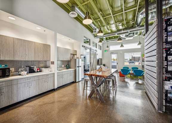 a kitchen with a wooden table and a refrigerator