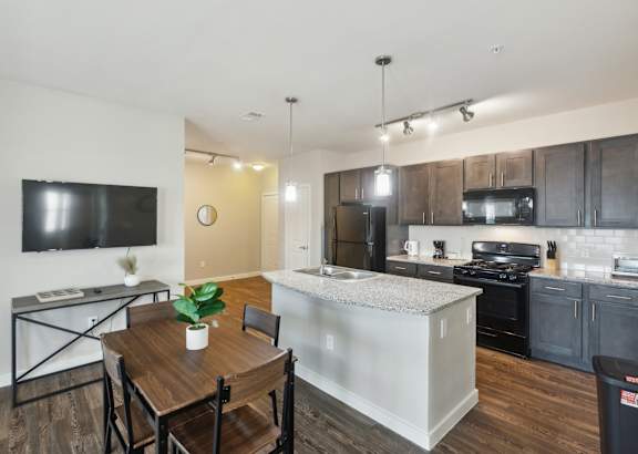 a kitchen with white cabinets and a granite counter top