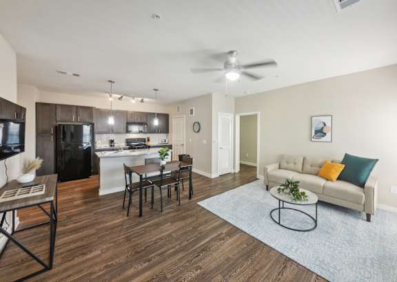 a living room filled with furniture and a ceiling fan
