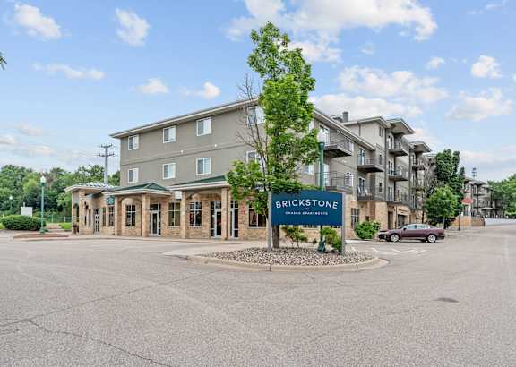 A large building with a sign that says Brickstone in front of it.