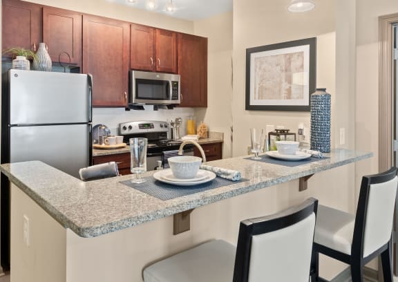 an empty kitchen with granite counter tops and stainless steel appliances at The Ridge at Chenal Valley, Little Rock, Arkansas