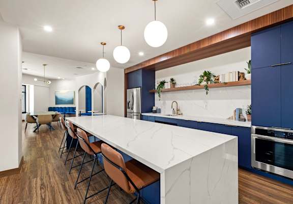 a large kitchen with blue cabinets and a white counter top