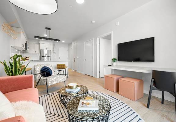 a living room with white walls and hardwood floors
