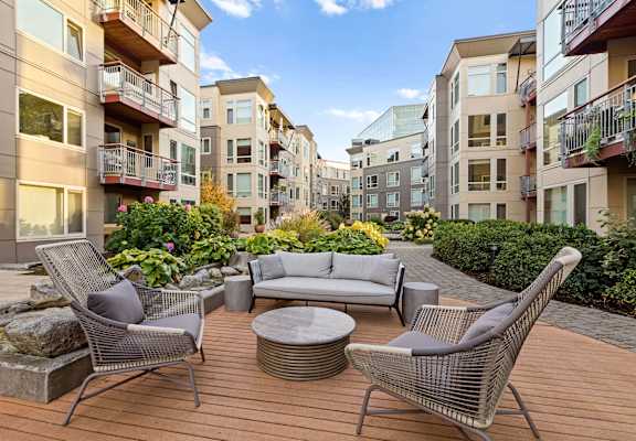 a patio with a couch and chairs on a