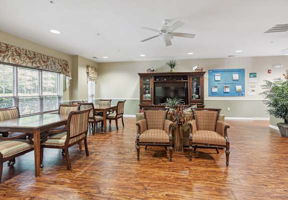 a room with a table and chairs and a fireplace