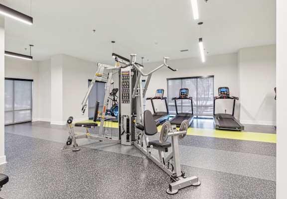 a gym with weights and cardio equipment in a building