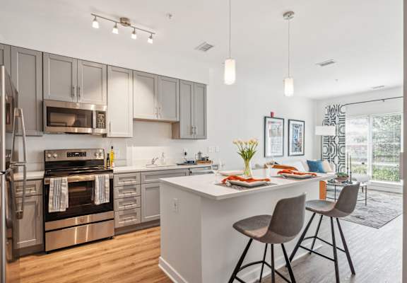 a kitchen with stainless steel appliances and an island with stools