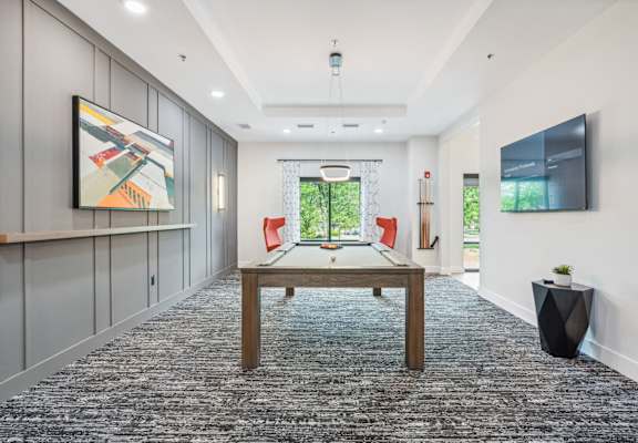 a games room with a ping pong table and a television