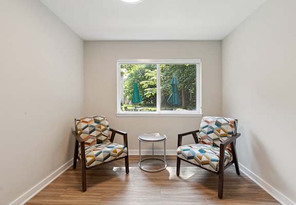 a therapy room with two chairs and a table