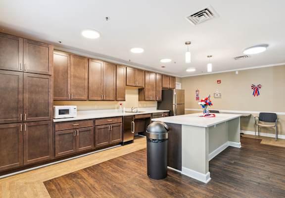 A kitchen with wooden cabinets and a white counter.