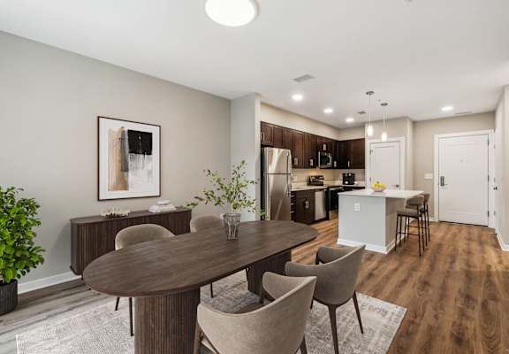A dining room with a table and chairs.