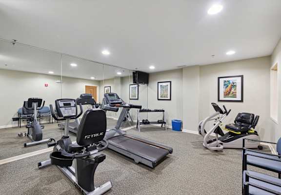 a gym with treadmills and other exercise equipment