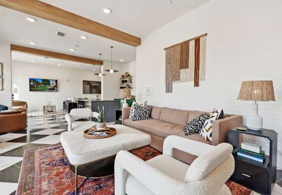 a living room filled with furniture and a checkered floor