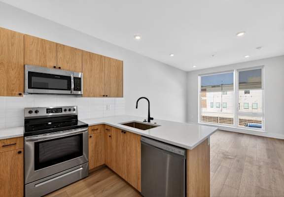 A kitchen with wooden cabinets and stainless steel appliances.