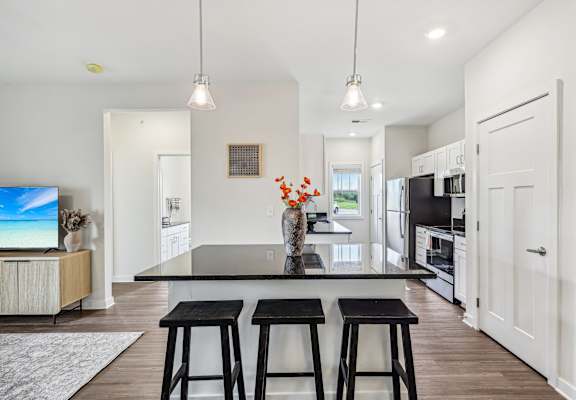 a kitchen with a center island and three stools