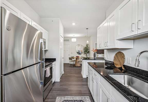 a kitchen with stainless steel appliances and white cabinets