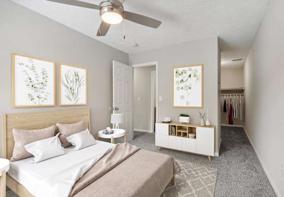 a bedroom with a bed and a ceiling fan