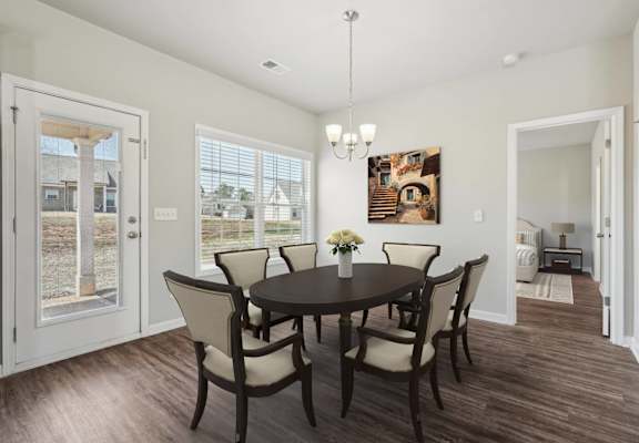 A dining room with a table set for four.
