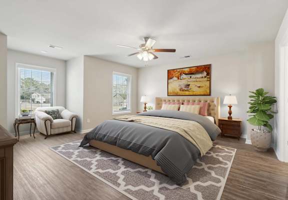 A bedroom with a large bed and a ceiling fan.