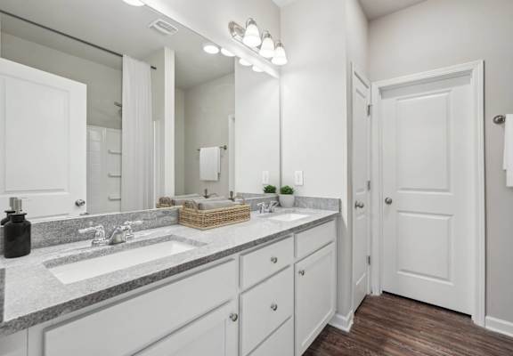 A bathroom with a white door and a white sink.