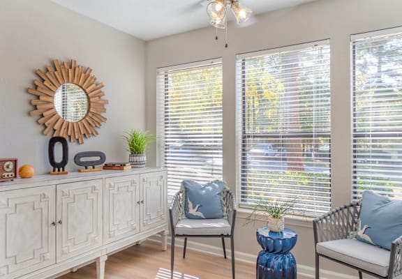 A sunny room with a chair and a table.